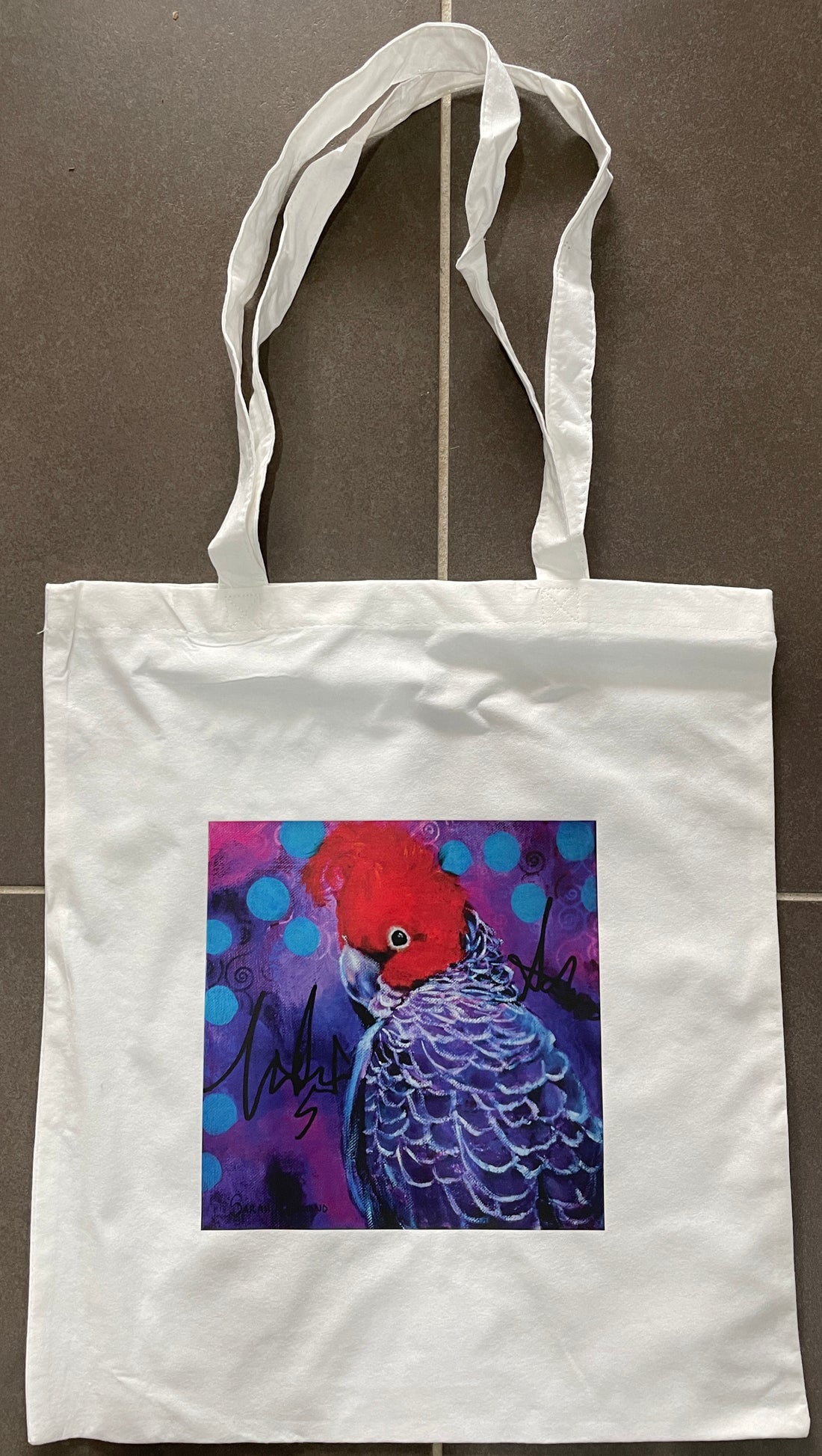 White bamboo tote bag featuring a print of an abstract realism Gang Gang Cockatoo on abstract background.